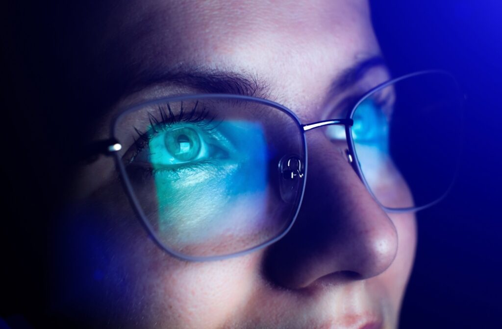 A close-up image of an adult wearing computer glasses to offset the effects of blue light on their eyes and circadian rhythm.