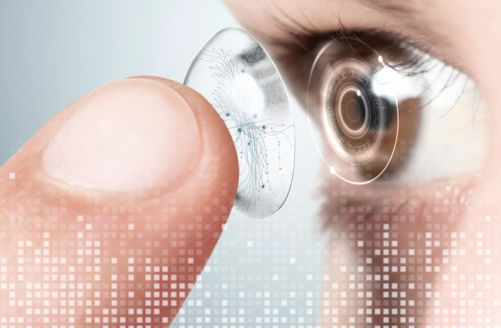 Close-up of a person inserting a contact lens into their eye with digital designs and pixelations to make it look futuristic.