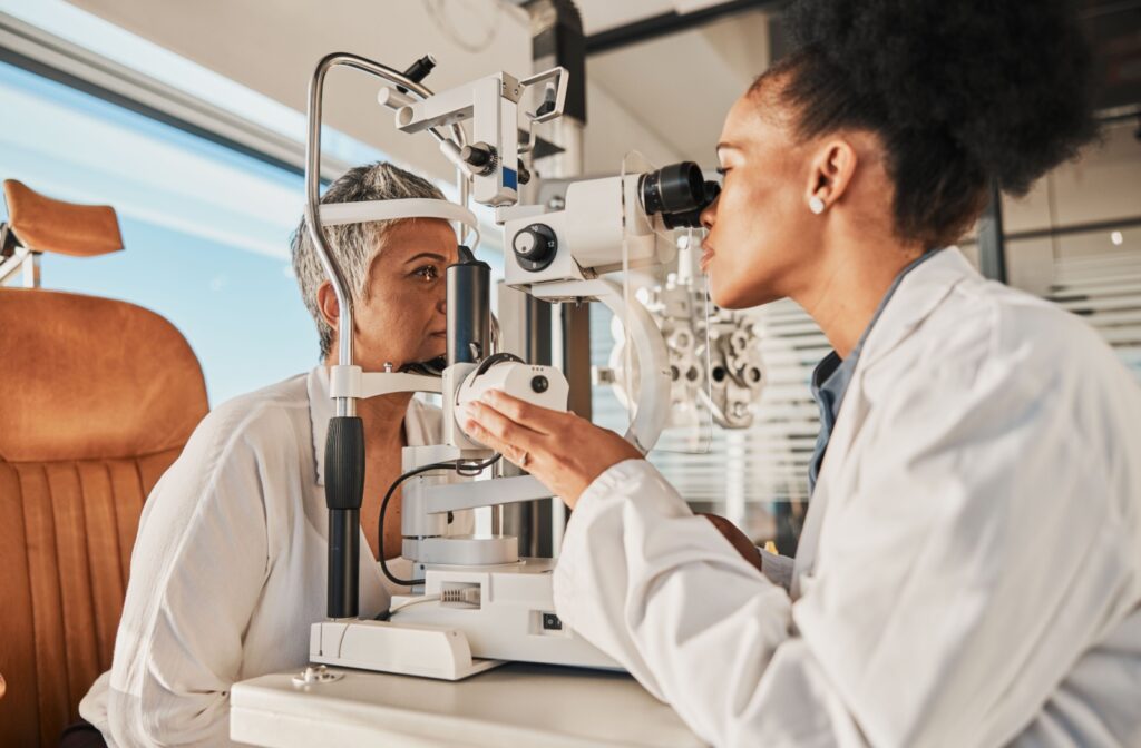 An eye doctor uses a slit lamp to evaluate a patient's eye health to uncover other causes of eye twitching.